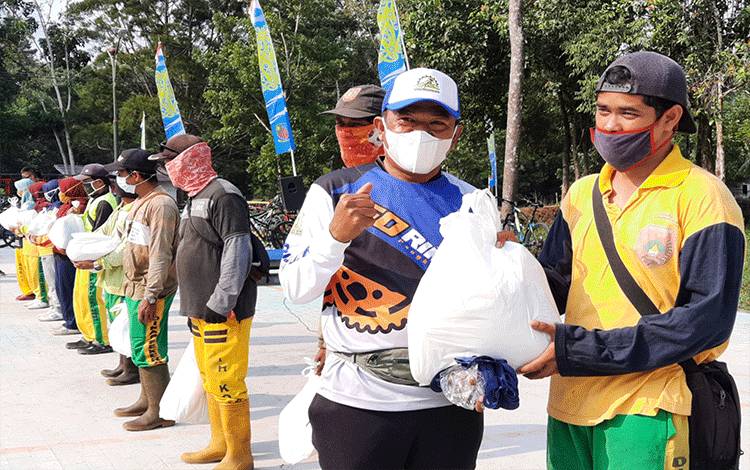 dr Fachruddin saat memberikan tali asih kepada petugas kebersihan, di sela - sela kegiatannya di area Jogging Track Lanud Iskandar Pangkalan Bun.