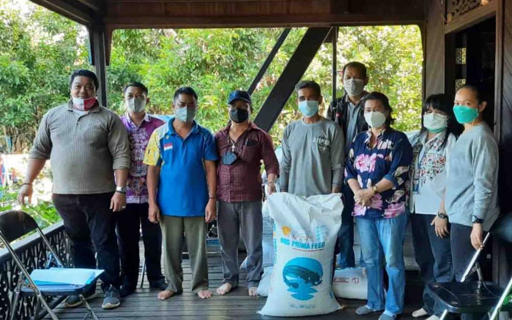 Anggota DPRD Kabupaten Gumas Rayaniatie Djangkan menyaksikan penyaluran bantuan benih dan pakan ikan kepada Pokdakan Hantaring I, di Kelurahan Tumbang Napoi, Kecamatan Miri Manasa, Rabu 28 Juli 2021.