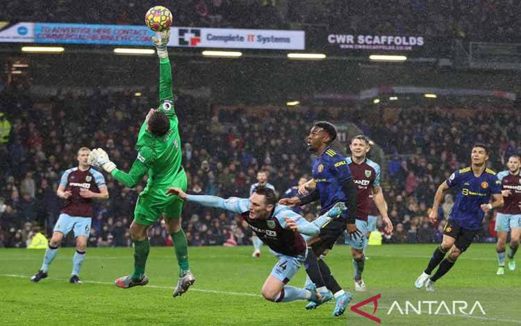 Kiper Burnley Nick Pope menepis bola saat laga liga Inggris melawan Manchester United di Turf Moor, Burnley, Inggris (8/2/2022)