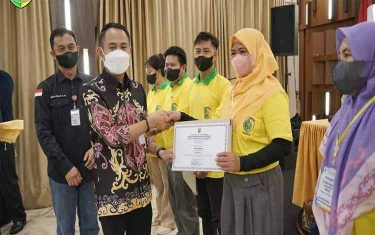 Wali Kota Palangka Raya, Fairid Naparin menyerahkan sertifikat pelatihan menganyam rotan. (FOTO: HUMAS PEMKO)