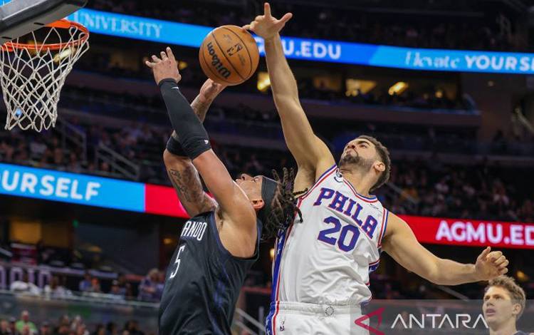 Forward Orlando Magic Paolo Banchero (5) merangsek ke keranjang dihadang forward Philadelphia 76ers Georges Niang (20) dalam paruh kedua lanjutan pertandingan NBA di Amway Center, Orlando, Florida, AS, 25 November 2022. (Reuters/Mike Watters-USA TODAY Sports)