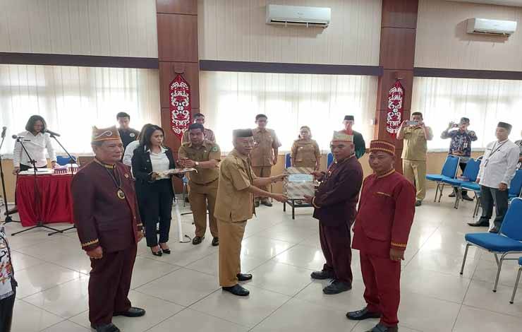 Plt Bupati Kapuas, Nafiah Ibnor saat menyerahkan SK kepada Damang Kepala Adat Kecamatan Kapuas Kuala dan Mandau Talawang usai dilantik, Senin, 31 Juli 2023. (FOTO: DODI)