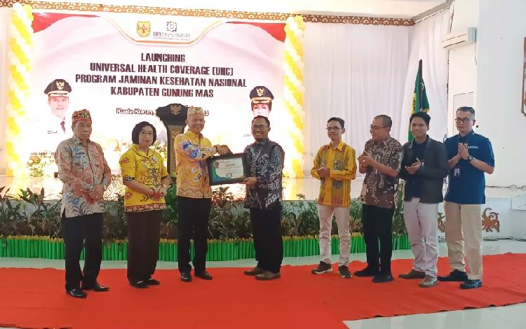 Bupati Gunung Mas Jaya S Monong saat menerima piagam penghargaan atas capaian UCH Kabupaten Gunung Mas dari pihak BPJS Kesehatan, Kamis, 21 September 2023. (FOTO: RISKA YULYANA)