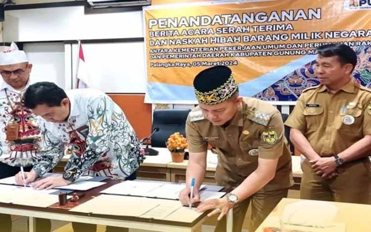 Bupati Gunung Mas Jaya S Monong dan lainnya menandatangani berita acara serah terima dan naskah hibah BMN di Palangka Raya, Kalteng. ANTARA/HO-Dinas PU Gunung Mas