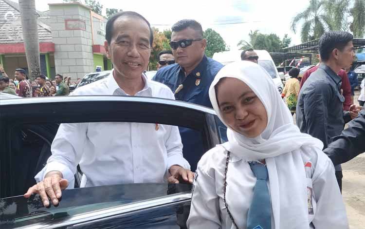 Sulistia Maharani, siswi kelas XI SMKN 1 Tamiang Layang Kabupaten Barito Timur saat berfoto dengan Presiden Jokowi di halaman RSUD Tamiang Layang, Kamis, 27 Juni 2024. (FOTO: BOLE MALO)