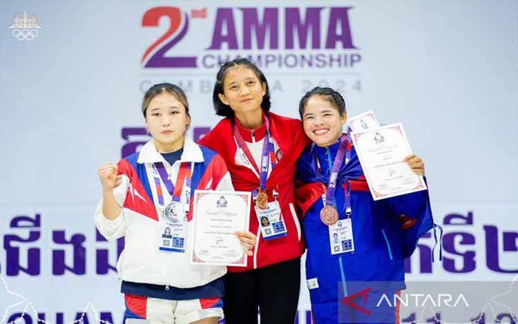 Atlet MMA Indonesia, Aprilia Eka Putri (tengah) meraih medali emas dalam 2nd Asian Mixed Martial Arts Championship Kelas Traditional MMA Putri -54kg saat berada di podium bersama Park Seo Young (KOR/kiri) peraih medali perak dan Srey Pov Nao (CAM/kanan) peraih perunggu dalam Kejuaraan Asia 2nd Asia Mixed Martial Arts Championships 2024 yang berlangsung di Phnom Penh, Kamboja, Sabtu (13/7/2024). (ANTARA/HO-PB Pertacami)
