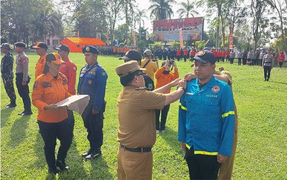 Pj Bupati Kapuas, Erlin Hardi saat menyematkan tanda kepada personel apel gabungan pada Selasa, 6 Agustus 2024. (FOTO: DODI)