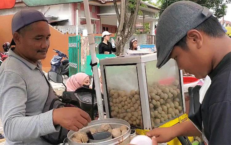 Narwoko salah satu penjual pentol yang memanfaatkan momen Pawai Pembangunan, Minggu, 18 Agustus 2024. (FOTO: DEWIP)