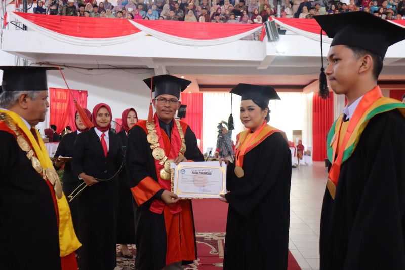 Rektor Unja Helmi memberikan penghargaan kepada wisudawan terbaik saat wisuda ke-111, Selasa (27/8/2024). (ANTARA/HO-Unja)