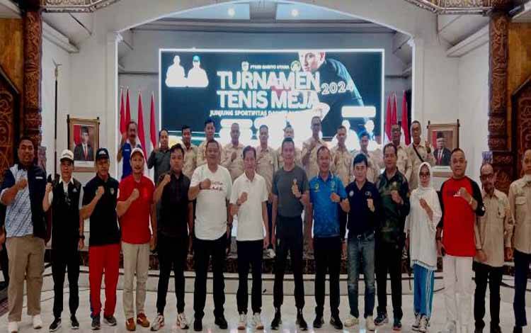 Pj Bupati Barito Utara, Muhlis didampingi Kapolres, Dandim 1013 Muara Teweh, Staf Ahli Bupati, Asisten Sekda, Kepala Perangkat Daerah dan pejabat lainnya foto bersama dengan pengurus PTMSI Barito Utara usai pembukaan kejuaraan tenis meja open Pj Bupati Barito Utara Cup tahun 2024 di gedung Balai Antang, Jumat 30 Agustus 2024.(foto: Dhani)
