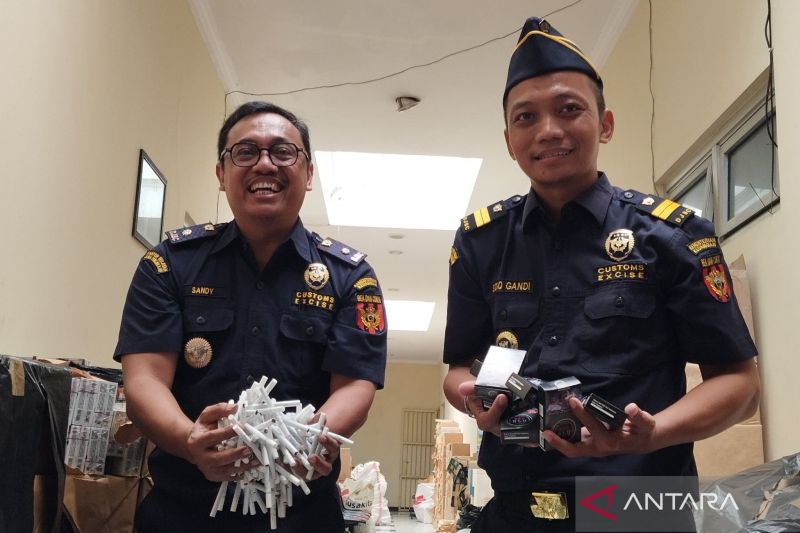 Kepala Seksi Penyuluhan dan Layanan Informasi KPPBC Tipe Madya Cukai Kudus Sandy Hendratmo Sopan bersama pemeriksa Bea dan Cukai Pertama Sidiq Gandi Baskoro menunjukkan rokok ilegal hasil pengungkapan. ANTARA/Akhmad Nazaruddin Lathif