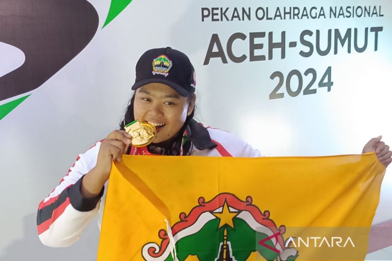 Atlet cabang olahraga atletik dari tim Jawa Tengah (Jateng), Wahyu Nur Aini, menggigit medali emas nomor lempar cakram putri dalam PON XXI Aceh-Sumut 2024 di Stadion Madya Atletik Sumut Sport Center, Kabupaten Deli Serdang, Sumatera Utara, Minggu (15/9/2024). ANTARA/Donny Aditra