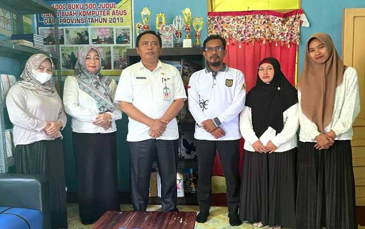 Kepala Disarpustaka Kapuas. Suwarno Muriyat bersama Kades Maluen usai kunjungan ke Perpusdes. (FOTO: IST)