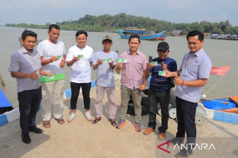 PT Timah Tbk saat menyerahkan kartu BPJS Ketenagakerjaan kepada nelayan tradisional di Bangka. ANTARA/HO-Humas PT Timah Tbk.