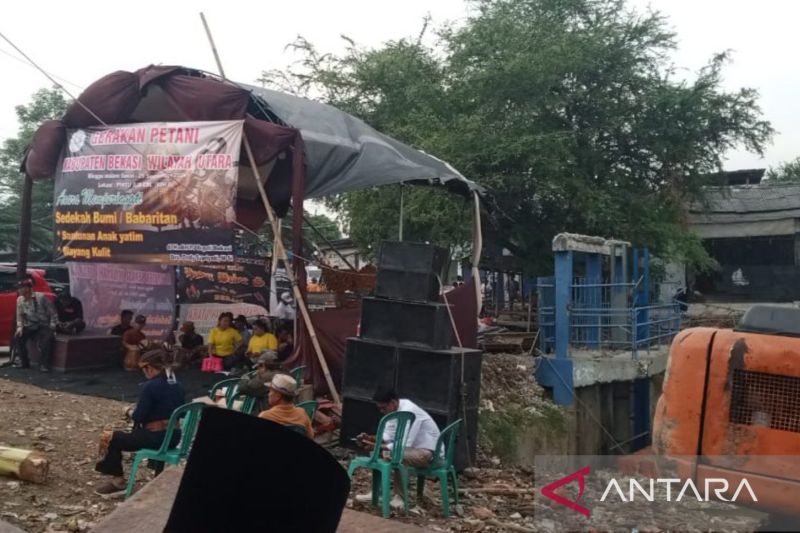 Sedekah bumi oleh para petani di wilayah utara Kabupaten Bekasi, Jawa Barat di Bendungan Kali Cikarang Bekasi Laut atau titik pertemuan antara Kali Cikarang dengan saluran irigasi menuju lahan pertanian. (ANTARA/Pradita Kurniawan Syah).