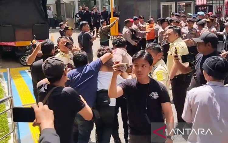 Para petugas keamanan mengeluarkan segerombolan pemuda mengenakan kaos putih bertuliskan #SaveKPK saat sidang kasus Sekjen DPP PDIP Hasto Kristiyanto di Pengadilan Tipikor Jakarta, Kamis (24/4/2025). (ANTARA/Agatha Olivia Victoria)