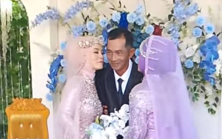 Tangkapan layar video ketua RT di Desa Bajarau didampingi 2 istrinya di pelaminan. (FOTO: IST)