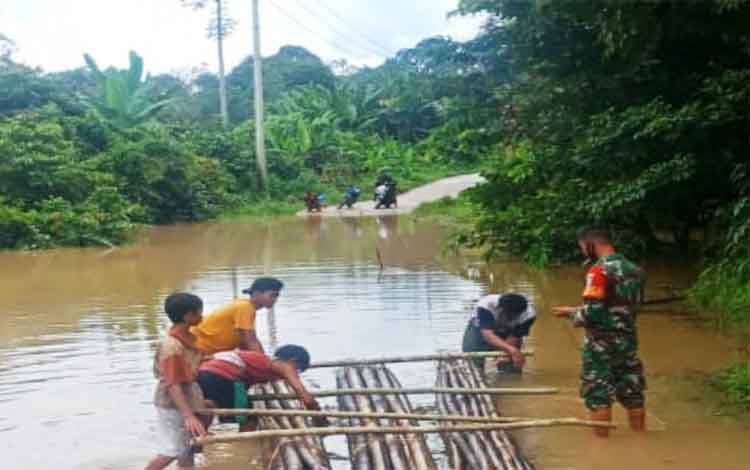 Babinsa Koramil Kandui Bantu Warga Sebrangi Luapan Air