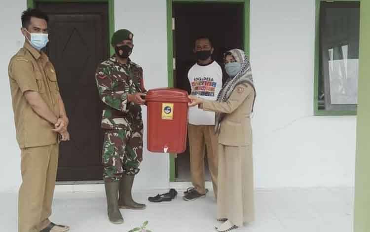Bagikan Tempat Cuci Tangan, Babinsa Kubu Ajak Masyarakat Disiplin Prokes